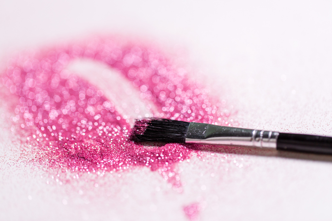 Make up Brush Making Stroke on Pink Glitters